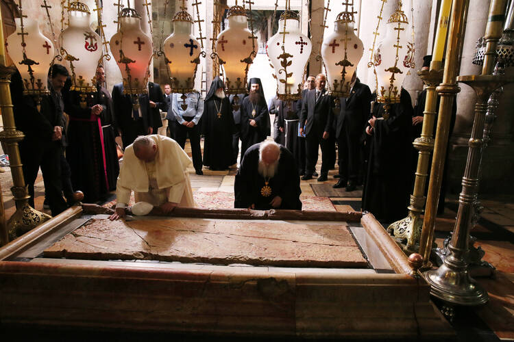 Pope Francis and Ecumenical Patriarch Bartholomew of Constantinople venerate the Stone of Unction in Jerusalem's Church of the Holy Sepulcher on May 25. 