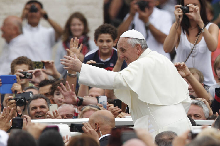 Pope greets crowd after celebrating Mass for catechists in St. Peter's Square, Sept. 29. (Paul Haring. CNS).