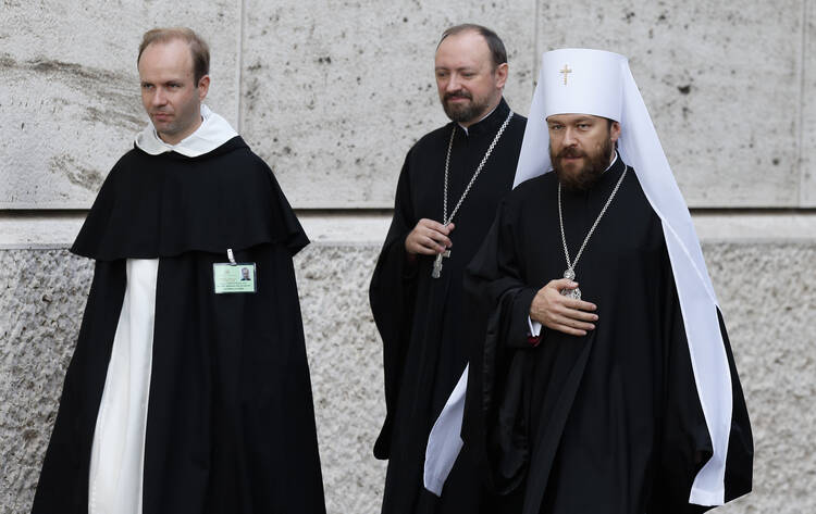 Metropolitan Hilarion of Volokolamsk, head of ecumenical relations for the Russian Orthodox Church, right, arrives for the morning session of the extraordinary Synod of Bishops on the family at the Vatican Oct. 16. (CNS photo/Paul Haring)