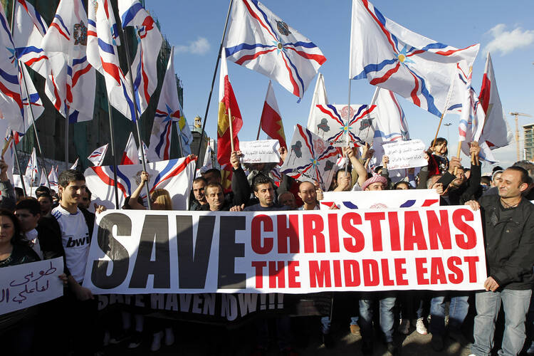 Christians who had fled the unrest in Syria and Iraq demonstrate in Beirut in February 2015. (CNS photo/Nabil Mounzer, EPA)