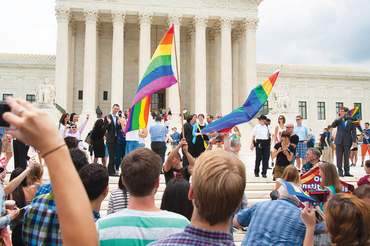 COURT'S CALLS. Supporters of same-sex marriage celebrate in front of the Supreme Court on June 26.