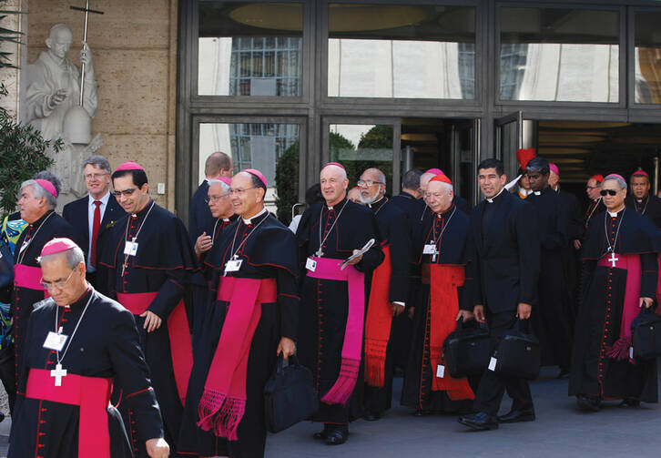 SYNODAL STROLL. Cardinals and bishops leave the Oct. 9 morning session at the Vatican.