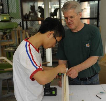 Fr. Terry Curry, SJ, helps Cheng Yuhai, a grad student at Tsinghua University, with his thesis project. (In Our Company Jesuit newsletter, February 13, 2014)