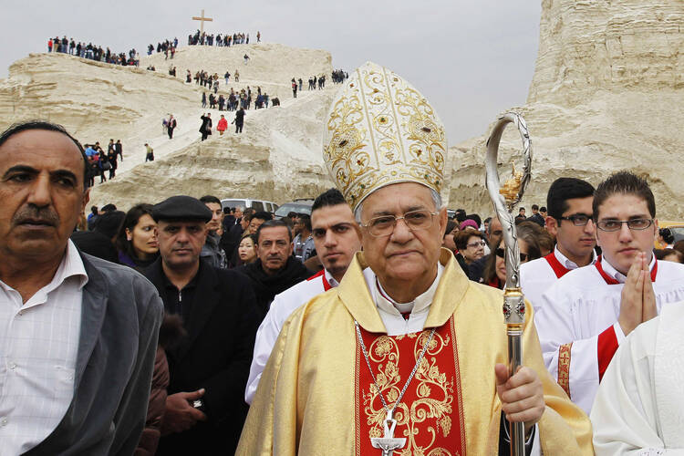 Latin Patriarch Faoud Twal of Jerusalem leads an annual pilgrimage at a baptism site on the Jordan River on Jan. 10..
