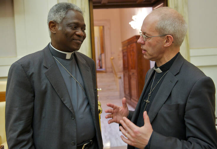 Cardinal Peter Turkson, president of the Pontifical Council for Justice and Peace, talks with Anglican Archbishop Justin Welby of Canterbury, spiritual leader of the Anglican Communion, after a Vatican meeting on human trafficking June 15.