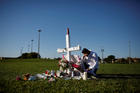 Joe Zevuloni weeps in front of a cross placed in a park to commemorate the victims of the shooting at nearby Marjory Stoneman Douglas High School in Parkland, Fla., on Feb. 16. At least 17 people were killed in the Feb. 14 shooting. (CNS photo/Carlos Garcia Rawlins, Reuters)