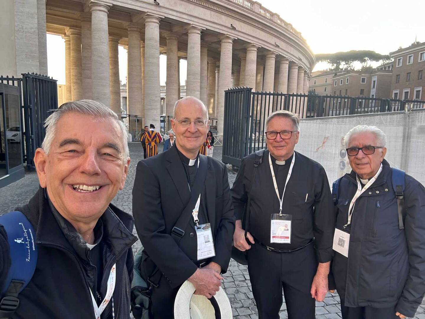 Father James Martin and synod delegates pose for a selfie outside the synod hall