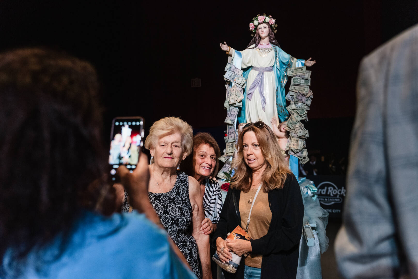 Attendees at Atlantic City’s 56th annual Wedding of the Sea pose for a photo with a statue of Mary. (Photo credit: John Kalitz)