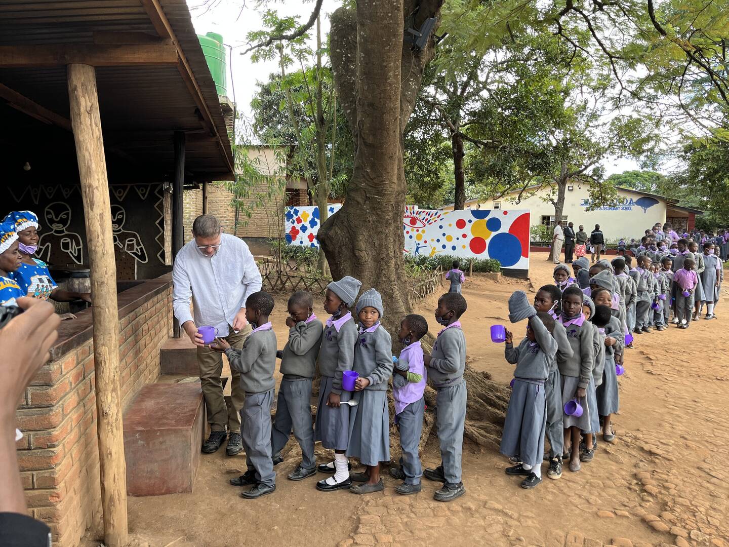 Magnus MacFarlane-Barrow is seen in a 2022 photograph serving school meals to Jacaranda Primary and Secondary School in Malawi. The charity started in 2002 with meal distribution to 200 children in two primary schools in that very country. Today, Mary's Meals serves meals to 2,429,182 children every school day across 17 countries. (OSV News photo/Graeme Little's Kenya Trip Photos, courtesy Mary's Meals)