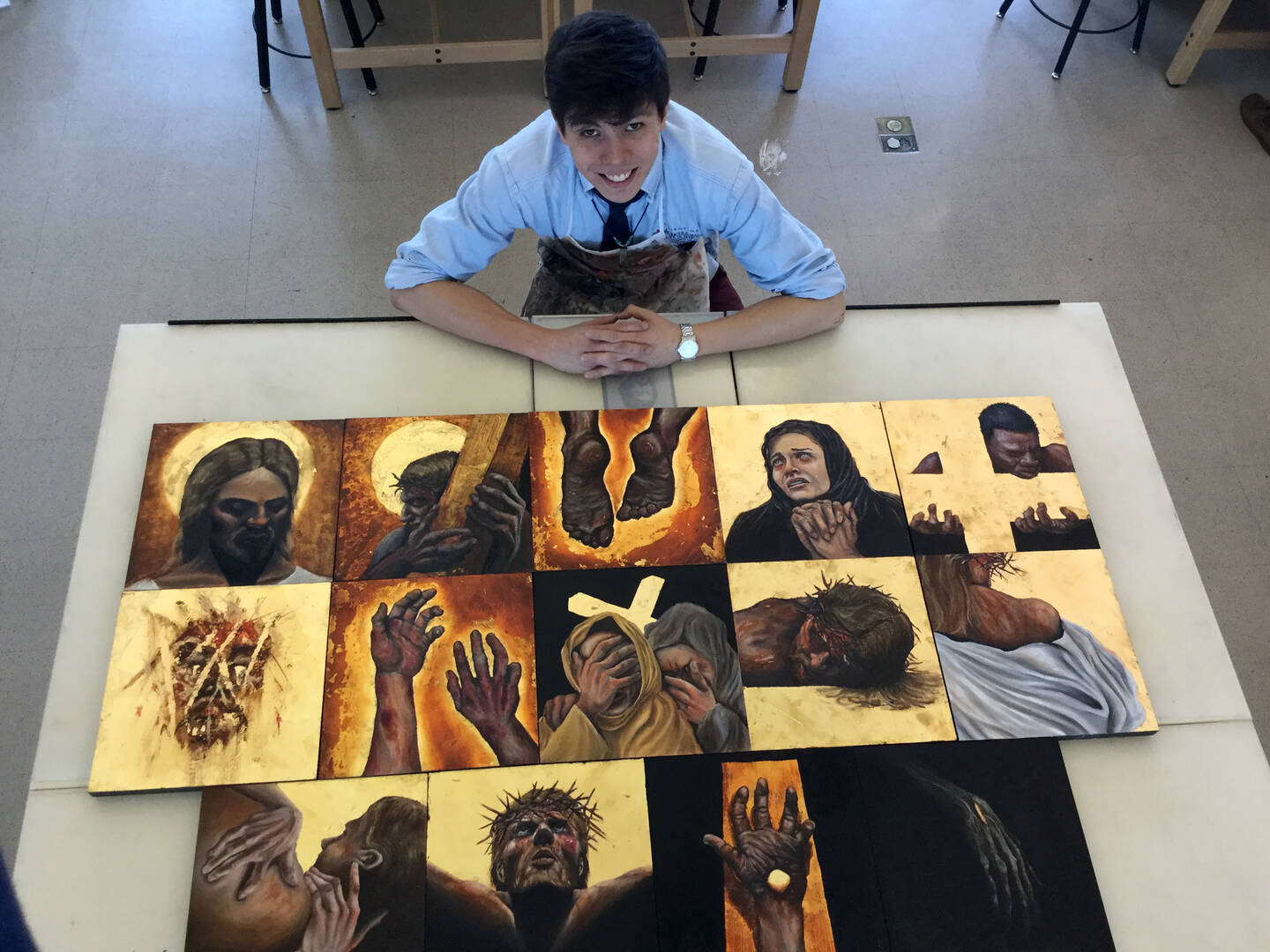 Irving Delgado-Arellanes shows the Stations of the Cross that he painted for the chapel at Creighton Prep.