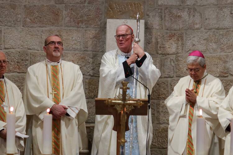 Cardinal Timothy M. Dolan of New York, center, holds his crozier during Mass at the Our Lady of Peace chapel in the Notre Dame of Jerusalem Center on April 13, 2024. (OSV News photo/Sinan Abu Mayzer, Reuters)