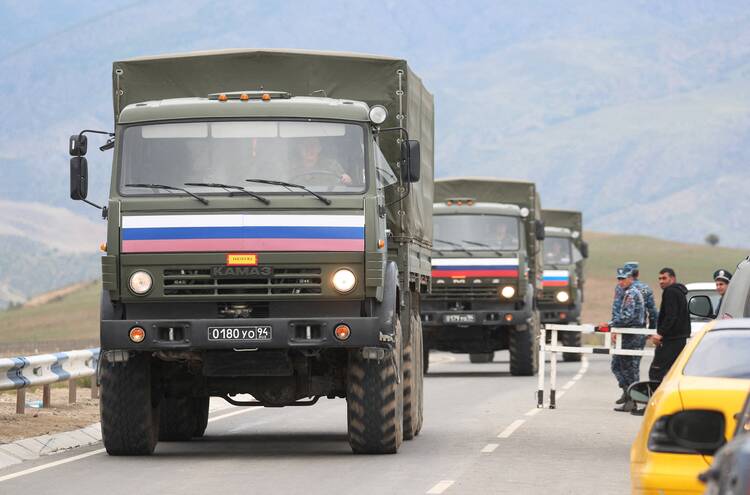 Vehicles of Russian peacekeepers leaving Azerbaijan's Nagorno-Karabakh region for Armenia pass an Armenian checkpoint on a road near the village of Kornidzor on Sept. 22, 2023. (OSV news photo/Irakli Gedenidze, Reuters)