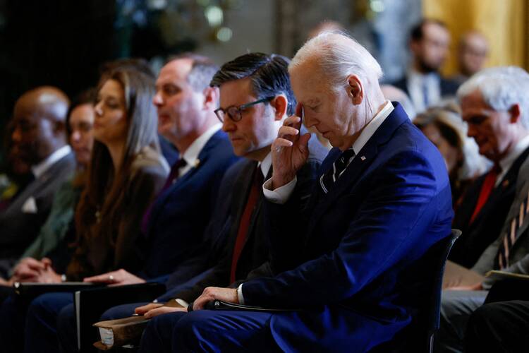 At center: Republican U.S. House Speaker Mike Johnson sits beside Democratic President Joe Biden during the annual National Prayer Breakfast at the U.S. Capitol in Washington on Feb. 1, 2024. (OSV News photo/Evelyn Hockstein, Reuters)