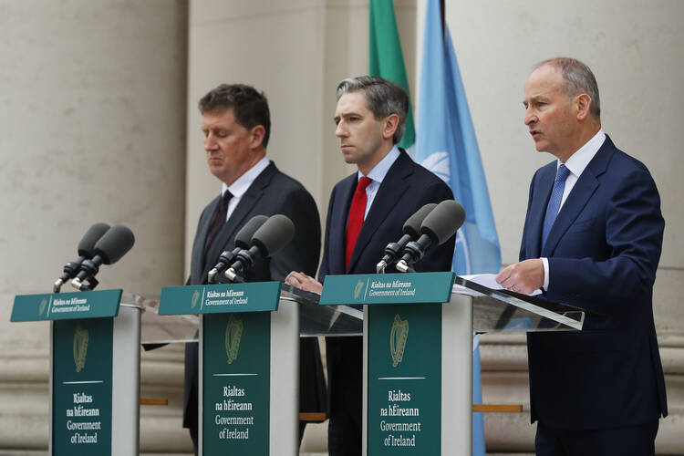 The three Irish Government leaders from left, Minister Eamon Ryan, Taoiseach Simon Harris and Tanaiste Micheal Martin speak to the media during a press conference outside the Government Buildings, in Dublin, Ireland, on May 22, 2024. European Union countries Spain and Ireland as well as Norway on Wednesday announced dates for recognizing Palestine as a state. (Damien Storan/PA via AP)
