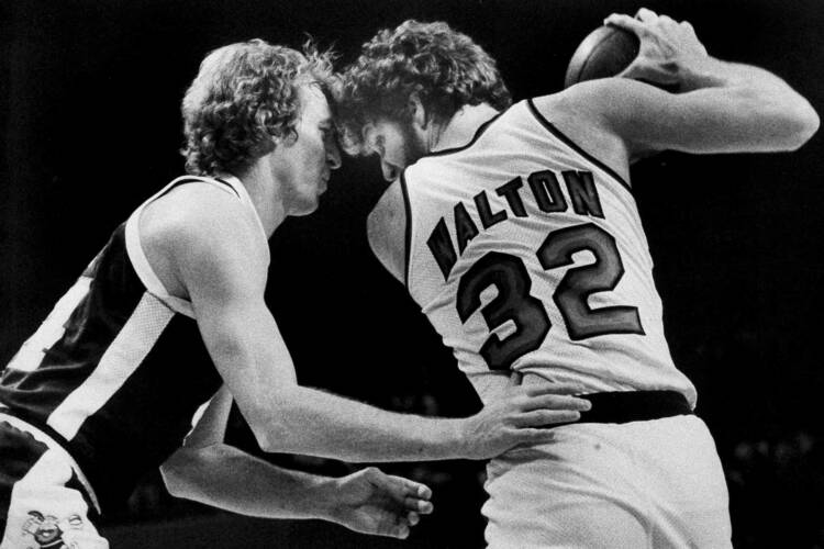 Denver Nuggets' Dan Issel, left, guards Portland Trail Blazers' Bill Walton as Walton moves towards the basket during their game in Portland, Ore., Feb. 12, 1978. 