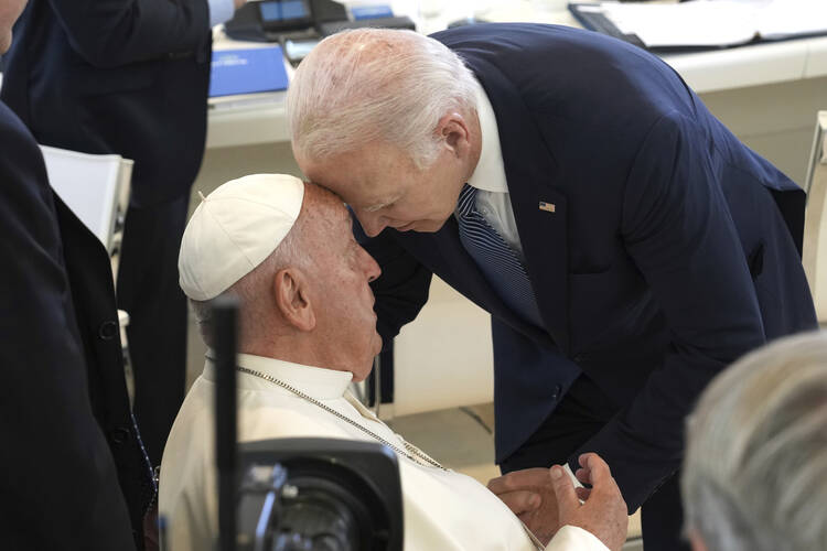 U.S. President Joe Biden, right, bends down to greet Pope Francis with their foreheads touching, ahead of a working session on Artificial Intelligence (AI), Energy, and Africa-Mediterranean, during the G7 summit at Borgo Egnazia, southern Italy, on June 14, 2024.