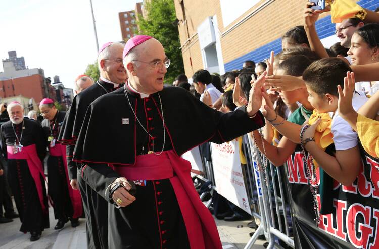 Archbishop Carlo Maria Viganò, then-apostolic nuncio to the United States, greets children during Pope Francis' visit to Our Lady Queen of Angels School in East Harlem, New York, in this Sept. 25, 2015, file photo (CNS photo/Eric Thayer/The New York Times, pool).
