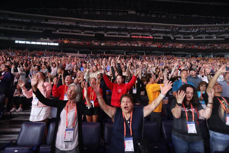 Pilgrims sing along with the Catholic musician Matt Maher during the July 20, 2024, revival night of the National Eucharistic Congress at Lucas Oil Stadium in Indianapolis. (OSV News photo/Bob Roller)