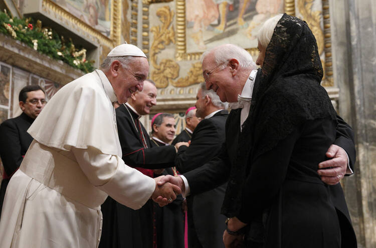 Pope Francis exchanges greetings with Ken Hackett, U.S. ambassador to the Holy See, and his wife, Joan, during a meeting with ambassadors to the Holy See at the Vatican, Jan. 13, 2014 (CNS photo/Paul Haring).