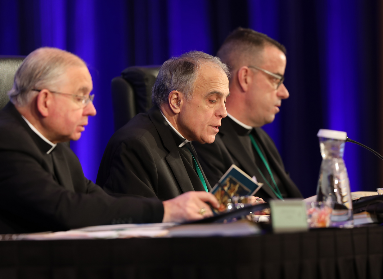 Cardinal Daniel N. DiNardo of Galveston-Houston, center, leads the opening prayer Nov. 12 during the fall general assembly of the U.S. Conference of Catholic Bishops in Baltimore. Also pictured are Archbishop Jose H. Gomez of Los Angeles, vice president of the USCCB, and Msgr. J. Brian Bransfield, general secretary. (CNS photo/Bob Roller)