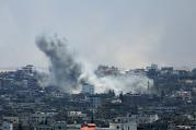 Smoke rises from Gaza City after an Israeli airstrike July 29. Violence escalated the previous night after an attempted unofficial truce for the three-day Eid al-Fitr holiday crumbled. (CNS photo/Mohammed Saber, EPA)