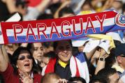 Woman holds a banner with Paraguay's national colors before Pope Francis' arrival to celebrate Mass in Nu Guazu Park in Asuncion, Paraguay, July 12. (CNS photo/Paul Haring) 