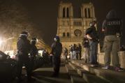 Armed police officers go on foot patrol around Notre Dame Cathedral in Paris Nov. 14. Dozens of people were killed in a series of attacks in Paris Nov. 13. (CNS photo/Ian Langsdon, EPA) 