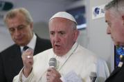 Pope Francis answers questions from journalists aboard his flight from Ciudad Juarez, Mexico, to Rome Feb. 17. 