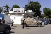 Yemeni pro-government fighters guard outside a Missionaries of Charity elderly home March 4 after unidentified gunmen targeted the home in Aden, Yemen. Four Missionaries of Charity and 10 to 12 other people were killed in the attack. (CNS photo/EPA)