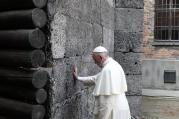 Pope Francis touches the death wall at the Auschwitz Nazi death camp in Oswiecim, Poland, July 29. (CNS photo/Paul Haring) 