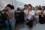 World Youth Day pilgrims kneel in prayer July 30 as Pope Francis leads the benediction during a prayer vigil at the Field of Mercy in Krakow, Poland. (CNS photo/Paul Haring) 