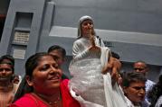 A woman holds a statuette of Mother Teresa outside the Missionaries of Charity building in Kolkata, India, Sept. 4. (CNS photo/Rupak De Chowdhuri, Reuters)