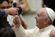  Pope Francis touches a rosary during his general audience in Paul VI hall at the Vatican Nov. 30. (CNS photo/Paul Haring) 