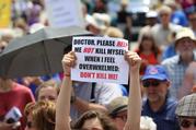 A woman holds up a sign during a rally against assisted suicide in 2016 on Parliament Hill in Ottawa, Ontario. (CNS photo/Art Babych)