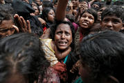 Rohingya refugees wait to receive aid Sept. 21 at a camp in Cox's Bazar, Bangladesh. (CNS photo/Cathal McNaughton, Reuters)