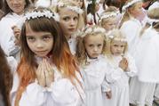 Girls gather for celebrations marking the feast of the Assumption in August 2012 in Aglona, Latvia. Twenty-five years after St. John Paul II visited Lithuania, Latvia and Estonia, Pope Francis will make the same three-nation visit Sept. 22-25, stopping at a number of the same places as his saint-predecessor. (CNS photo/Ints Kalinins, Reuters)