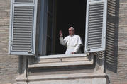 Pope Francis is seen in a window greeting a few nuns standing in St. Peter's Square at the Vatican March 22, 2020, after reciting his weekly Angelus prayer from the library of the Apostolic Palace. (CNS photo/Alberto Lingria, Reuters)