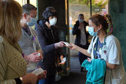 Nurse Jessica Juliano receives a chocolate bar from physician liaison Allison Damiano as she arrives to begin her shift on Easter, April 12, 2020, at Good Samaritan Hospital Medical Center in West Islip, N.Y. (CNS photo/Gregory A. Shemitz, Long Island Catholic)