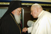 St. John Paul II greets Ecumenical Patriarch Bartholomew in 2002. Marking the 25th anniversary of St. John Paul II's encyclical on Christian unity, Pope Francis said he shares "the healthy impatience" of those who think more can and should be done, but he also insisted that Christians must be grateful for the progress made. (CNS photo/Reuters) 