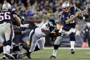 In this Dec. 6, 2015 photo, New England Patriots quarterback Tom Brady (12) scrambles away from Philadelphia Eagles defensive end Fletcher Cox (91) during a game in Foxborough, Mass. (AP Photo/Steven Senne, File).