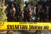 Police officers stand guard near the site where an explosion went off at Santa Maria church in Surabaya, East Java, Indonesia, Sunday, May 13, 2018. Media reports say simultaneous attacks on churches in Indonesia's second largest city of Surabaya have killed a number of people. (AP Photo/Trisnadi)