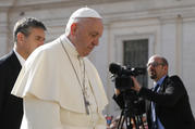  Pope Francis walks past a video journalist during his general audience in St. Peter's Square at the Vatican April 25. (CNS photo/Paul Haring) 