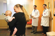 Nine-month-old Conner Walkenhorst and his mother, Jennifer Walkenhorst, visit in July 2017 with Dr. Nadeem Parkar and Dr. Wilson King, physicians instrumental in the creation of a three-dimensional model of Conner’s heart at SSM Health Cardinal Glennon Children’s Hospital in St. Louis. The model allowed for detailed planning of the baby’s successful heart transplant surgery. (Betsy Taylor/CHA)