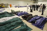 The bodies of African migrants lie in a hangar of the Lampedusa airport