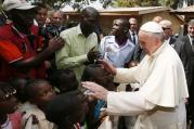 Pope Francis greets children as he visits a refugee camp in Bangui, Central African Republic, Nov. 29 (CNS photo/Paul Haring). 