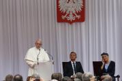 Pope Francis speaks as Polish President Andrzej Duda and first lady Agata Kornhauser-Duda attend a meeting with government authorities and the diplomatic corps in the courtyard of Wawel Royal Castle in Krakow, Poland, July 27 (CNS photo/Paul Haring).